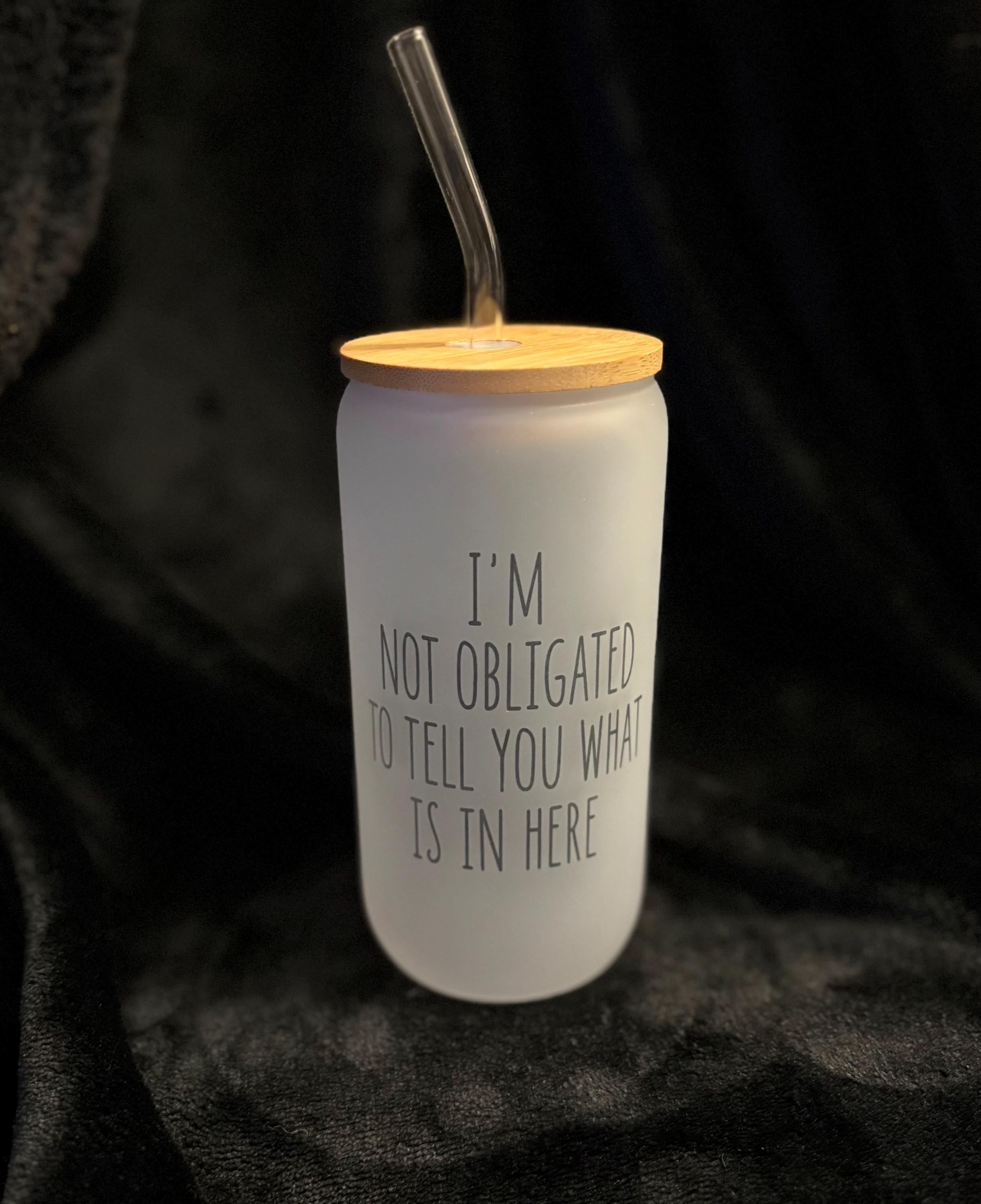 White tumbler with wooden lid and straw on a dark background